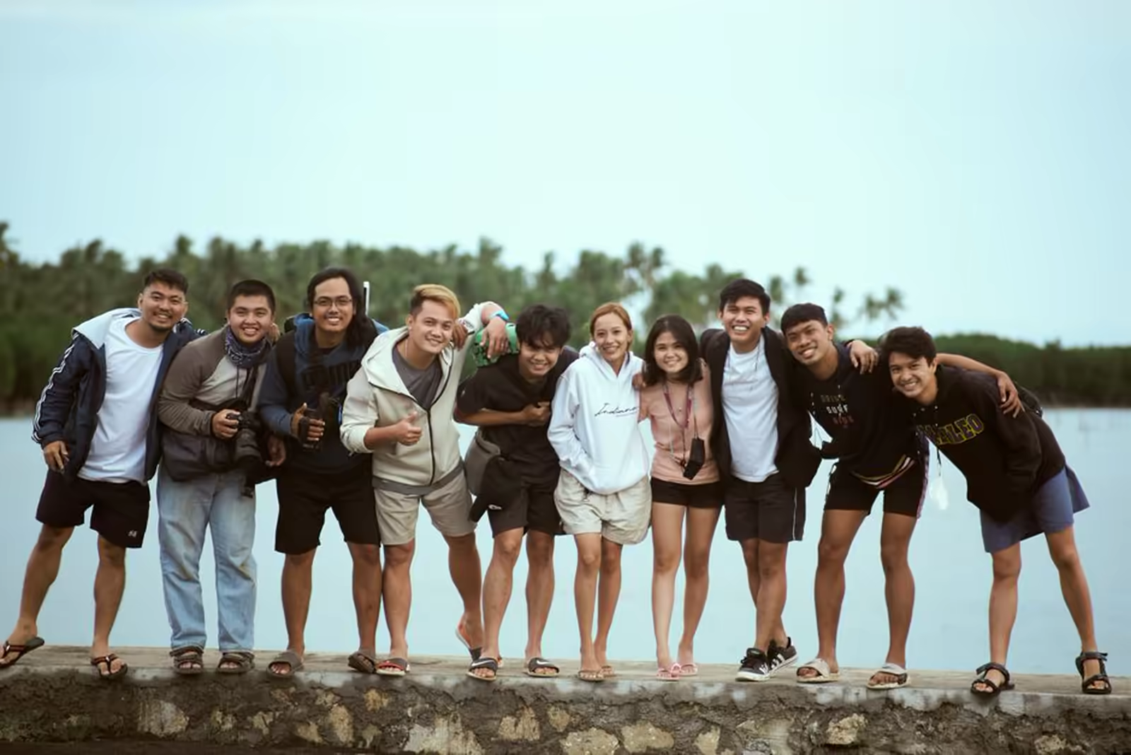 Group members together on a day trip, smiling at the camera