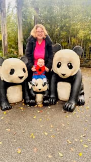 A support worker and child at a wildlife park.