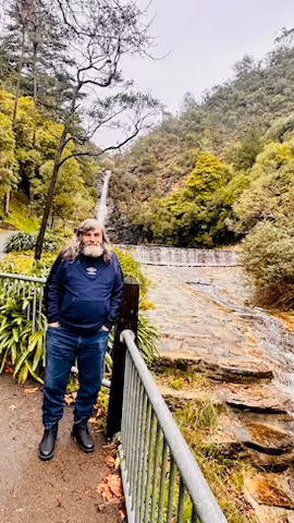 A participant on a walk to a waterfall.