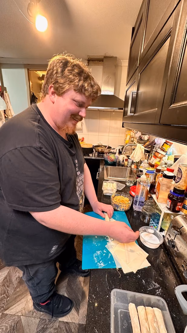 A participant preparing a meal in the kitchen.
