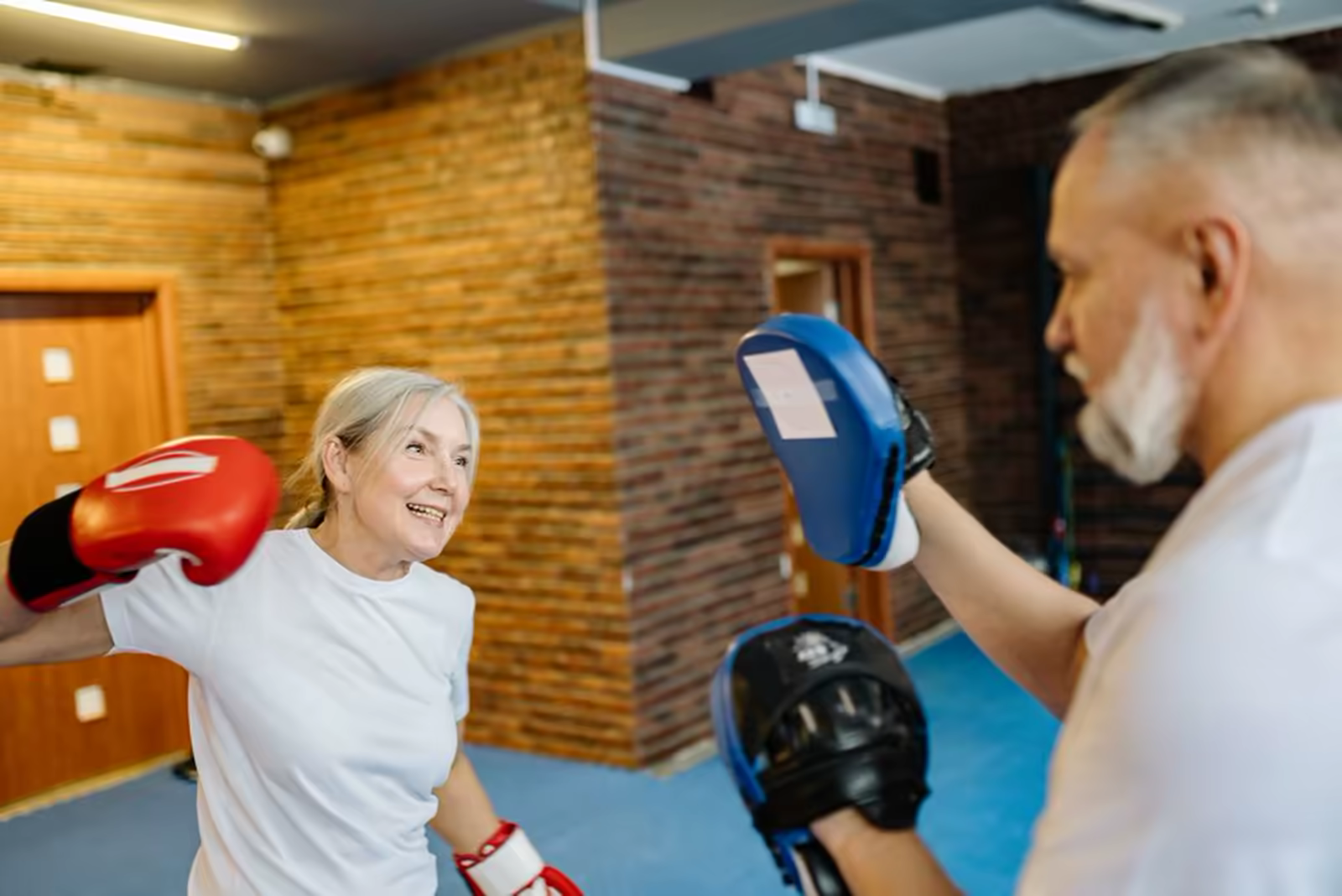 Adults smiling during a gentle group fitness class