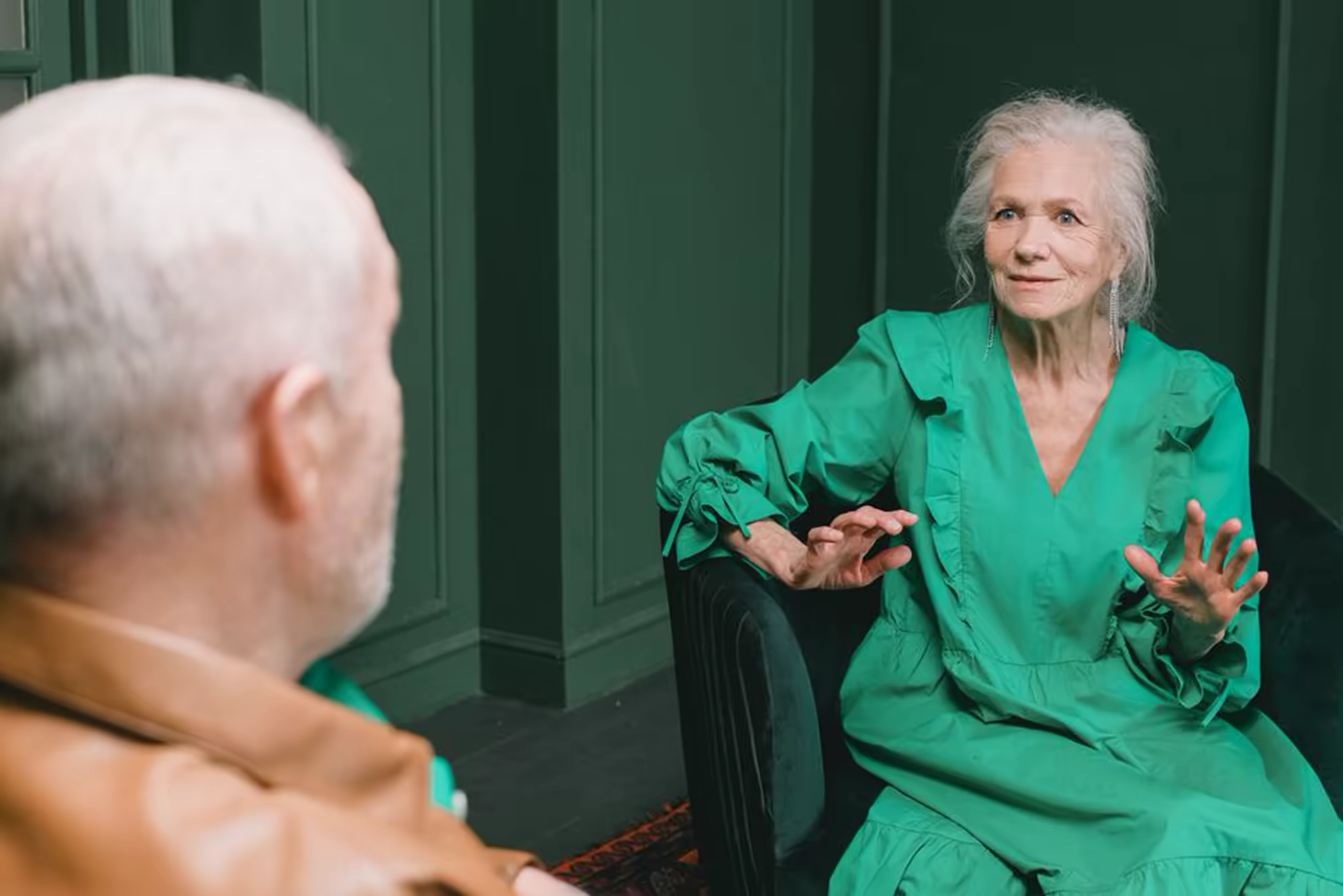A support worker and a participant talking together at home
